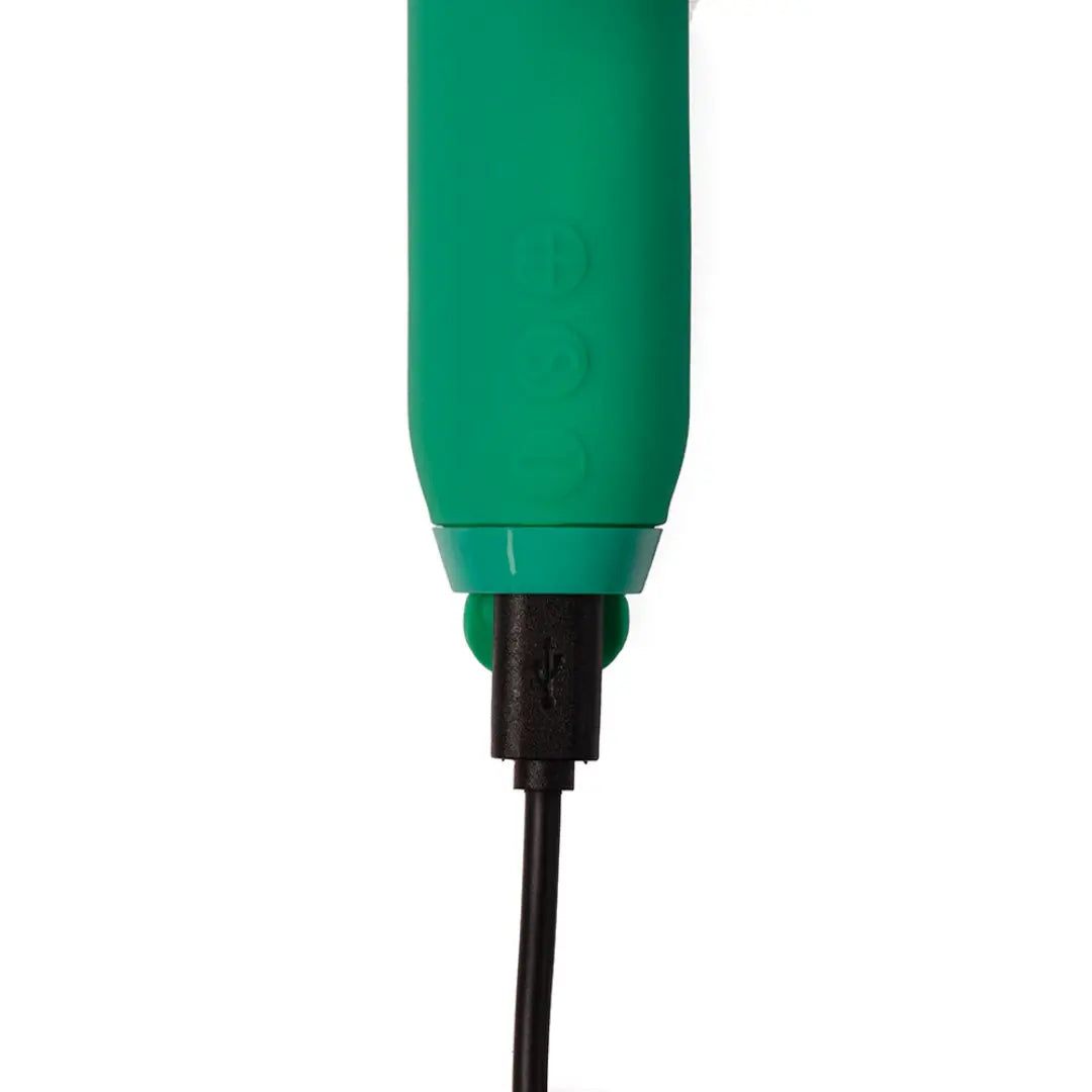 Je Joue Amour slim vibrator in emerald green showing three-button control panel and USB charging port
