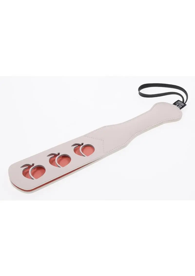 Peaches N Creame vegan leather paddle with peach shaped cut outs