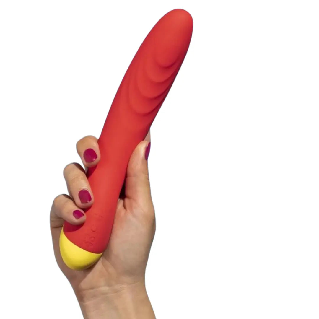 Orange-red seven inch Romp Hype vibrating dildo held in hand