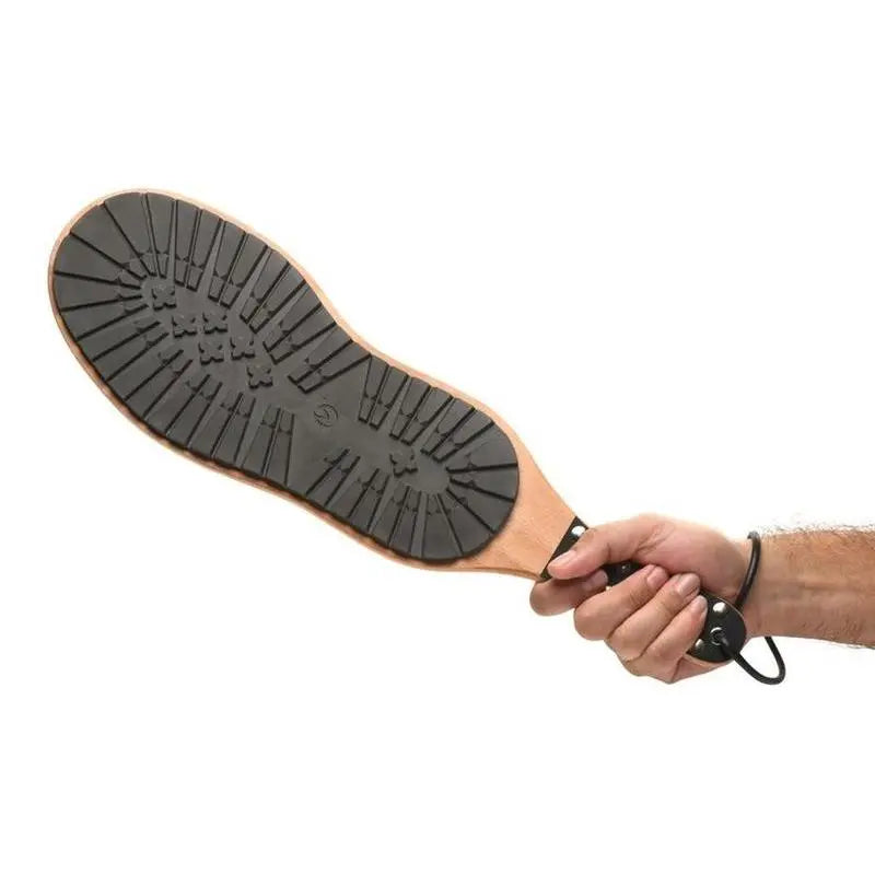 BDSM spanking paddle with rubber boot tread